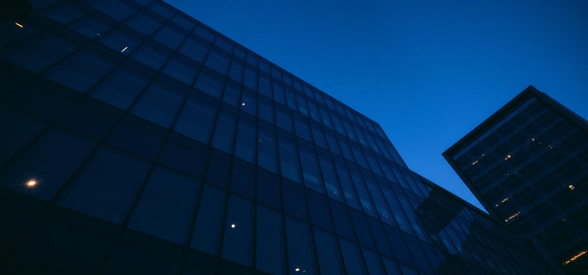 Modern glass office building at dusk